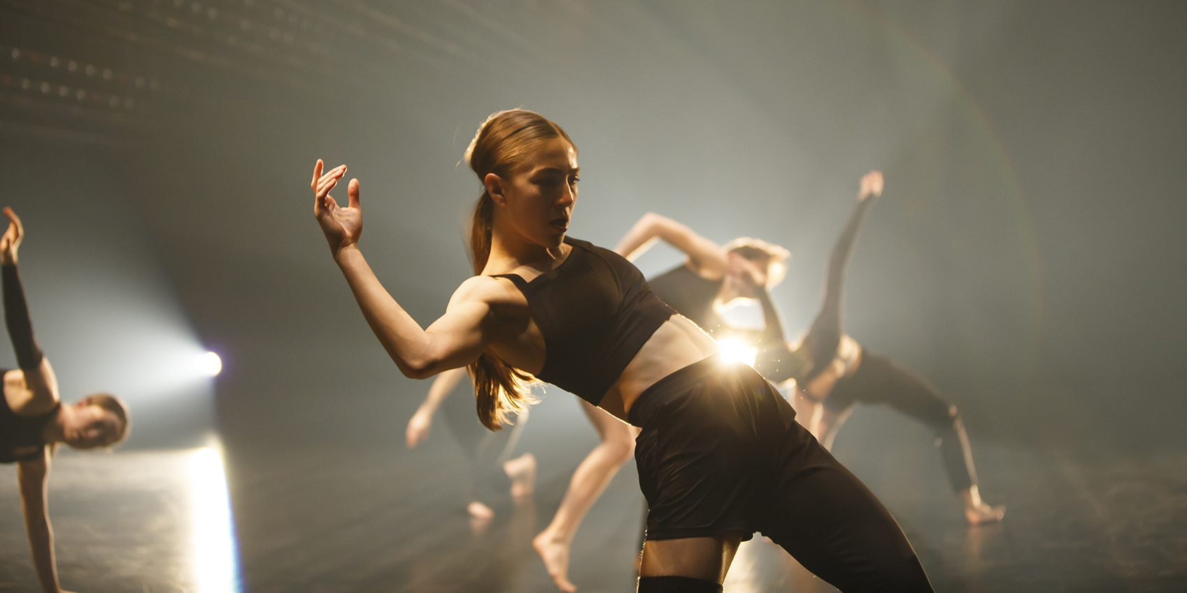 RUBBERBAND Restless Underdog: dancers in black on backlit stage