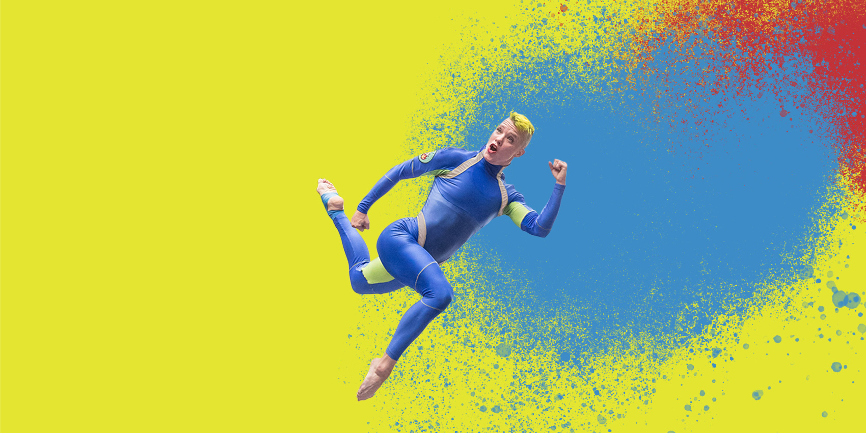 Dancer in blue suit jumping against bright background with paint splatters