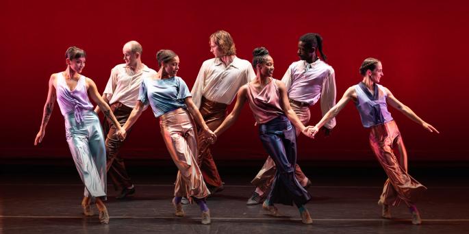 Mark Morris Dancers on stage against a red background