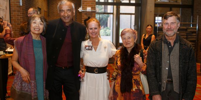 Five people in formal attire smiling