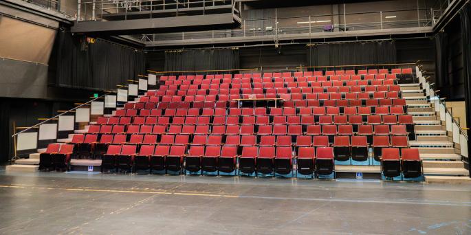 intimate theatre with empty red seats