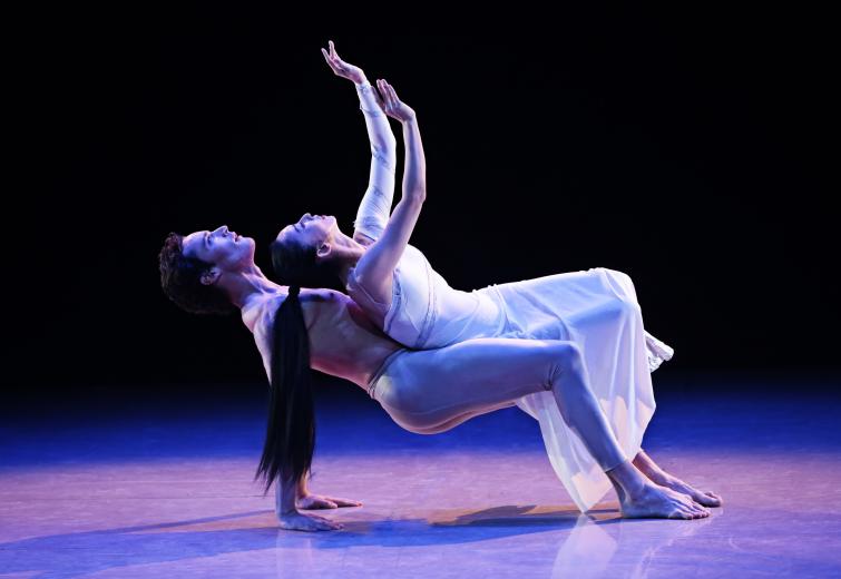 A male and female dancer perform on a stage.